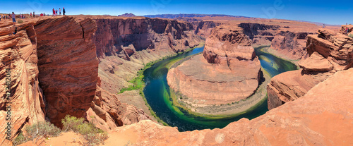 HORSESHOE BEND, AZ - JUNE 2018: Tourists wait for sunset on the top of the canyon