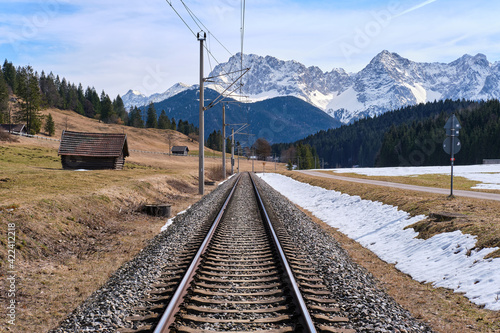 The railway road on the background of Alps mountains in the snow in Klais, Krün, Bayern
