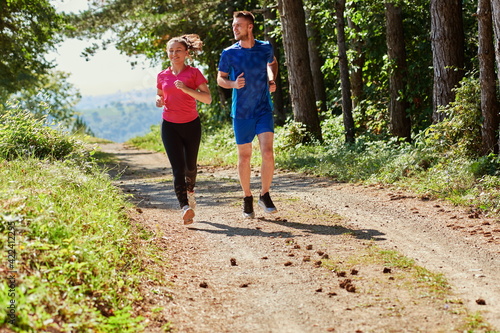 couple enjoying in a healthy lifestyle while jogging on a country road © .shock