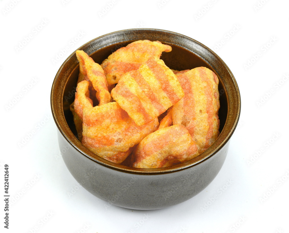 Bowl of bacon-flavored puffed wheat chips. Bacon Chips. Delicious bacon snacks isolated on white background. Pelleted salted snack bacon. Smoked bacon flavored chips. Bowl of bacon-flavored puffed wheat chips. Bacon Chips. Delicious bacon snacks isolated on white background. Pelleted salted snack bacon. Smoked bacon flavored chips.