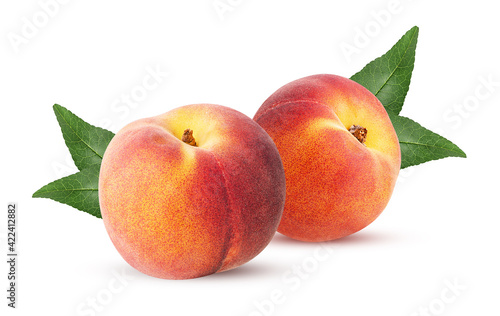 Two ripe peach fruit with leaf