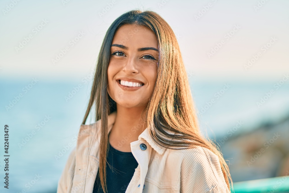 Young hispanic girl smiling happy standing at the promenade. Young hispanic girl smiling happy standing at the promenade.