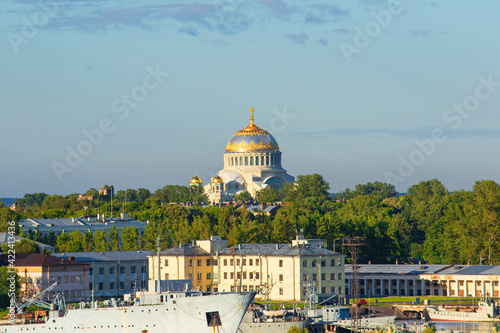 Landscape View of the Naval Cathedral of Saint Nicholas in Kronstadt near St. Petersburg, Russian Federation. Naval shipyard in the foreground. Early morning light.