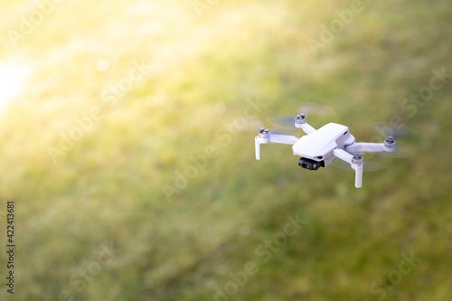 A drone flying outdoor, zoom photo, technology theme
