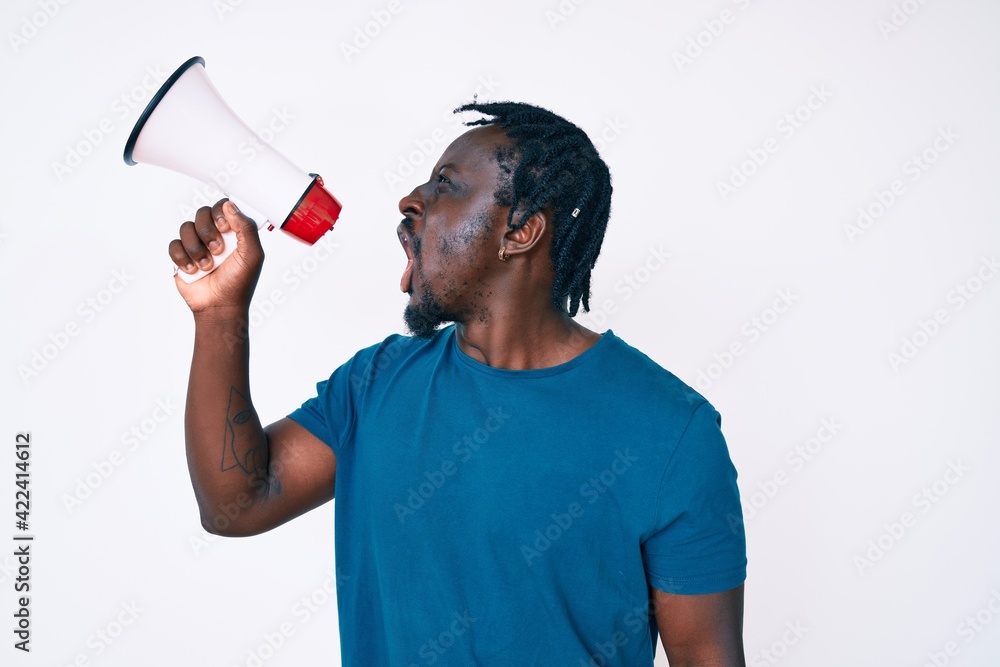 Young handsome african american man screaming using megaphone over isolated white background Young handsome african american man screaming using megaphone over isolated white background