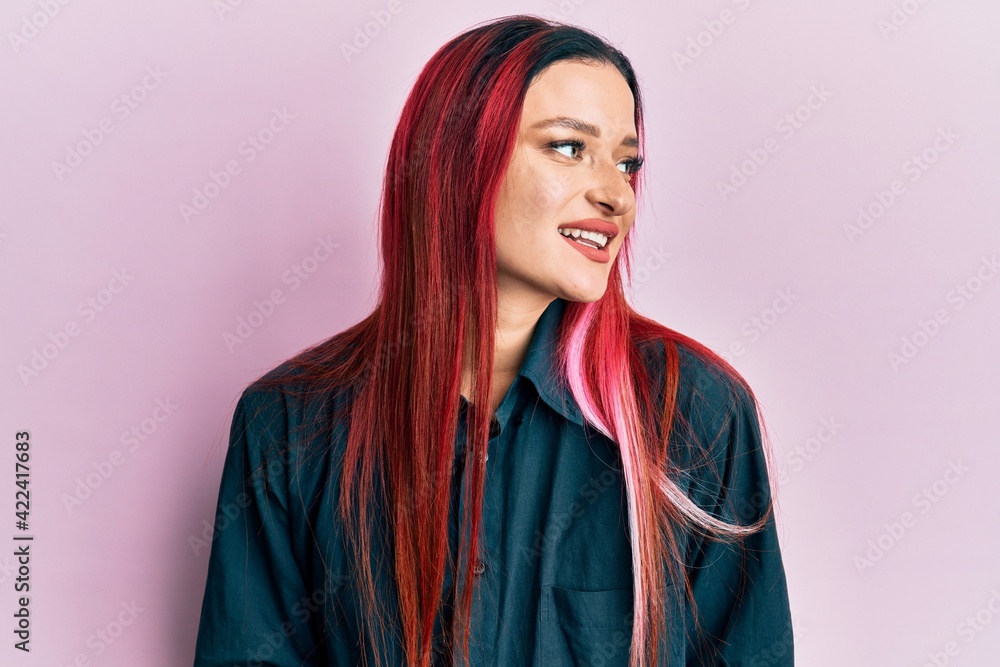 Young caucasian woman wearing casual clothes looking to side, relax profile pose with natural face and confident smile. Young caucasian woman wearing casual clothes looking to side, relax profile pose with natural face and confident smile.