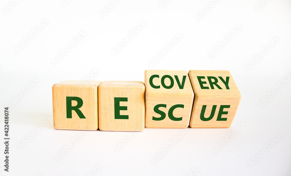 Recovery and rescue symbol. Turned cubes and changed the word 'recovery' to 'rescue'. Beautiful white background. Business and recovery - rescue concept. Copy space. Recovery and rescue symbol. Turned cubes and changed the word 'recovery' to 'rescue'. Beautiful white background. Business and recovery - rescue concept. Copy space.