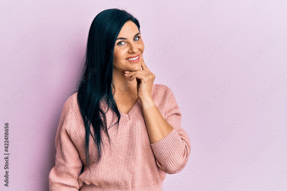 Young caucasian woman wearing casual clothes looking confident at the camera smiling with crossed arms and hand raised on chin. thinking positive. Young caucasian woman wearing casual clothes looking confident at the camera smiling with crossed arms and hand raised on chin. thinking positive.
