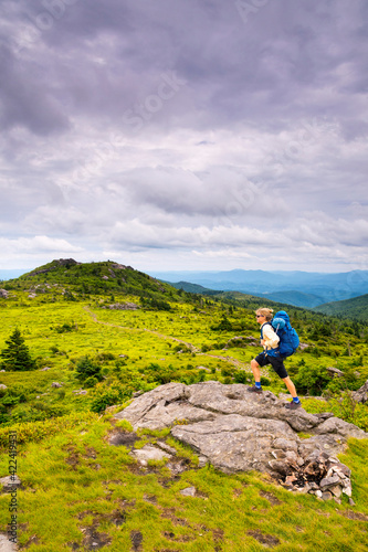 A woman hiking the Wilburn Ridge Tail section of the Appalachian Trail, Grayson Highlands, Mouth of Wilson, Virginia. photo