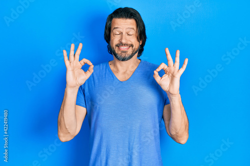 Middle age caucasian man wearing casual clothes relax and smiling with eyes closed doing meditation gesture with fingers. yoga concept.