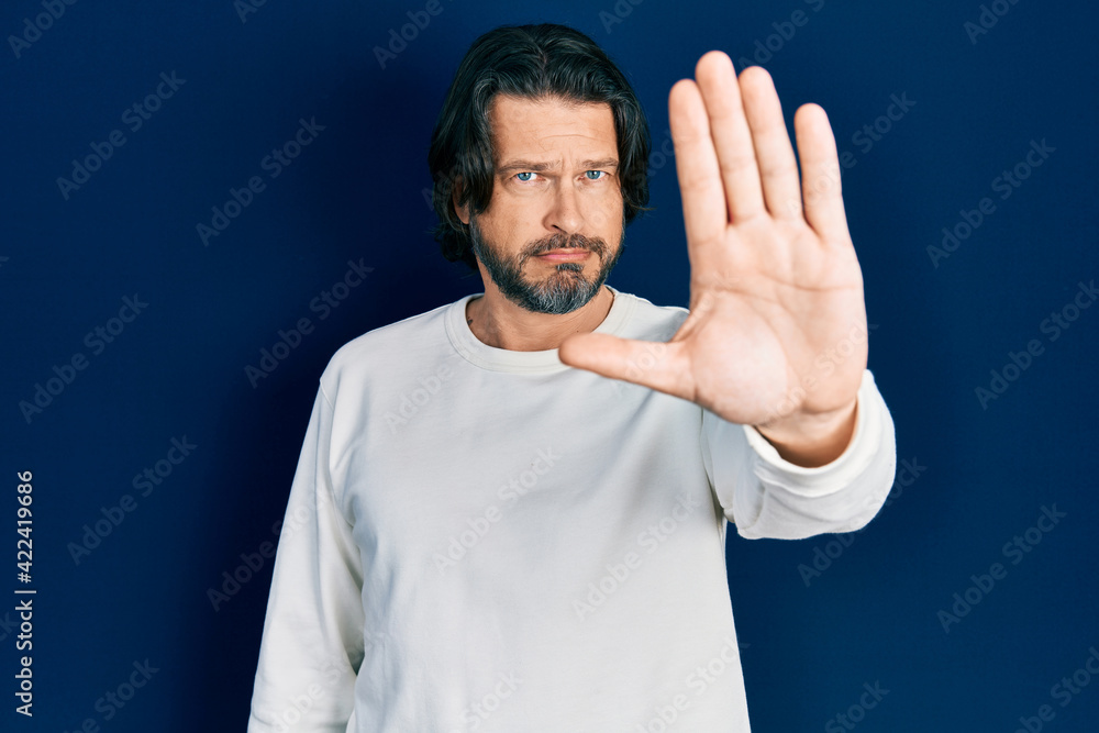 Middle age caucasian man wearing casual clothes doing stop sing with palm of the hand. warning expression with negative and serious gesture on the face. Middle age caucasian man wearing casual clothes doing stop sing with palm of the hand. warning expression with negative and serious gesture on the face.