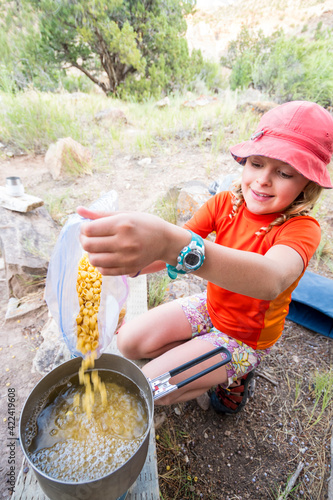 A girl cooking in the Gunnison Gorge Wilderness, Montrose, Colorado. photo