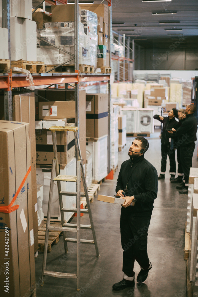 Businessman examining at distribution warehouse Businessman examining at distribution warehouse