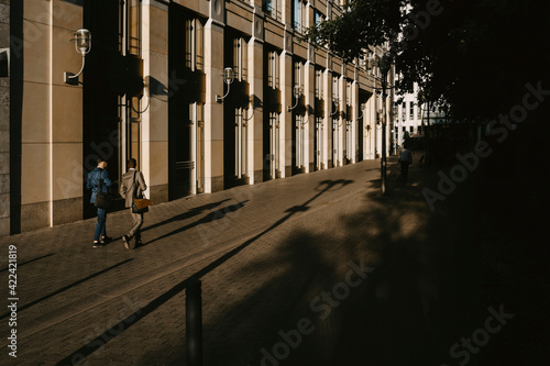 Wallpaper Mural Rear view of male colleagues walking while discussing on footpath in city Torontodigital.ca