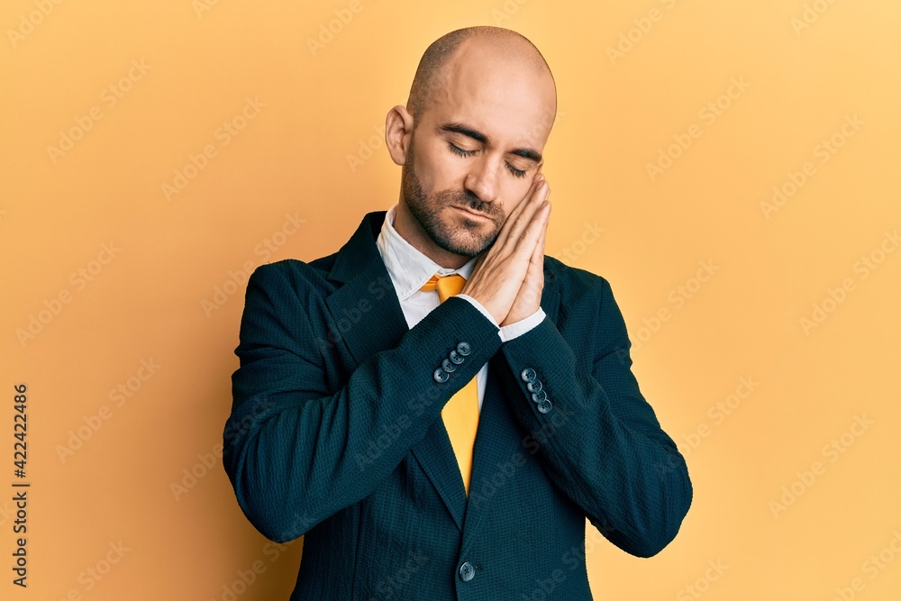 Young hispanic man wearing business suit and tie sleeping tired dreaming and posing with hands together while smiling with closed eyes. Young hispanic man wearing business suit and tie sleeping tired dreaming and posing with hands together while smiling with closed eyes.
