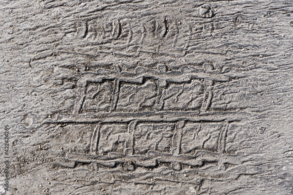 Melt asphalt imprint. Tyre mark texture. Tire track on the road background. Highway street damaged with sunlight heat. Car wheel shape on street. Melt asphalt imprint. Tyre mark texture. Tire track on the road background. Highway street damaged with sunlight heat. Car wheel shape on street.