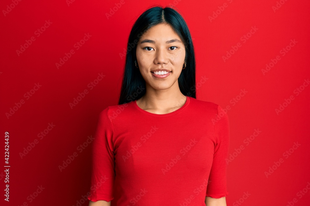 Young chinese woman wearing casual clothes with a happy and cool smile on face. lucky person. Young chinese woman wearing casual clothes with a happy and cool smile on face. lucky person.