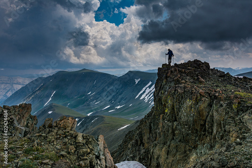 Male climber on ridge, Absaroka Mountains near Cody and Meeteetse, Wyoming, USA, Washakie Wilderness. photo