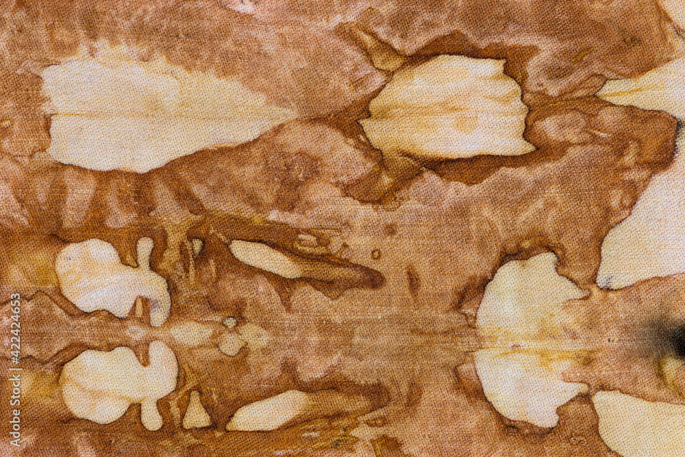 detail of a pattern in brown-ocher batik on a cotton fabric detail of a pattern in brown-ocher batik on a cotton fabric