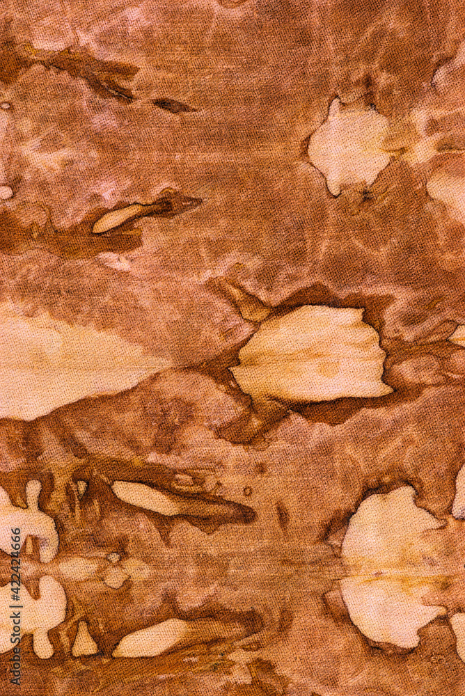detail of a pattern in brown-ocher batik on a cotton fabric