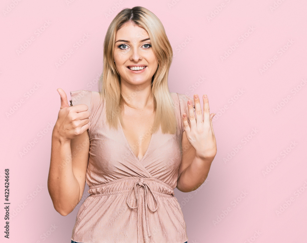 Young caucasian woman wearing casual clothes showing and pointing up with fingers number six while smiling confident and happy. Young caucasian woman wearing casual clothes showing and pointing up with fingers number six while smiling confident and happy.