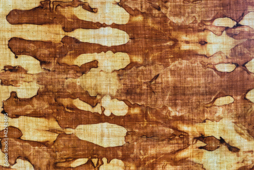 detail of a pattern in brown-ocher batik on a cotton fabric