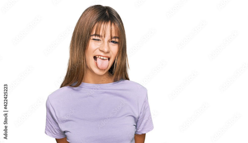 Teenager caucasian girl wearing casual clothes sticking tongue out happy with funny expression. emotion concept. Teenager caucasian girl wearing casual clothes sticking tongue out happy with funny expression. emotion concept.