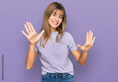 Teenager caucasian girl wearing casual clothes showing and pointing up with fingers number ten while smiling confident and happy.