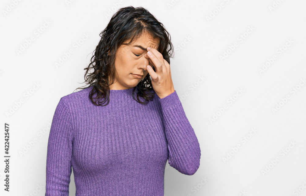 Young hispanic woman wearing casual clothes tired rubbing nose and eyes feeling fatigue and headache. stress and frustration concept. Young hispanic woman wearing casual clothes tired rubbing nose and eyes feeling fatigue and headache. stress and frustration concept.