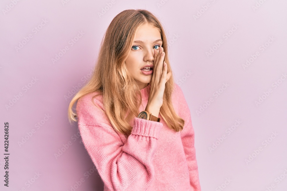 Beautiful young caucasian girl wearing casual clothes hand on mouth telling secret rumor, whispering malicious talk conversation Beautiful young caucasian girl wearing casual clothes hand on mouth telling secret rumor, whispering malicious talk conversation
