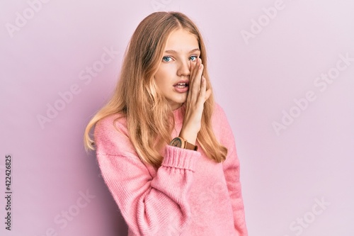 Beautiful young caucasian girl wearing casual clothes hand on mouth telling secret rumor, whispering malicious talk conversation