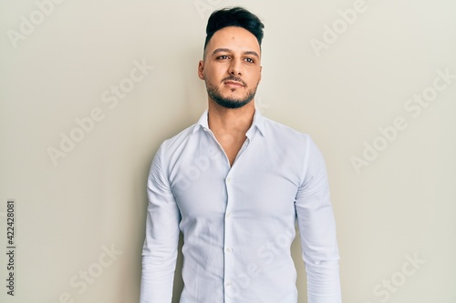 Young arab man wearing casual clothes looking to side, relax profile pose with natural face and confident smile.
