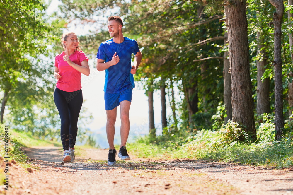 Fototapeta premium couple enjoying in a healthy lifestyle while jogging on a country road