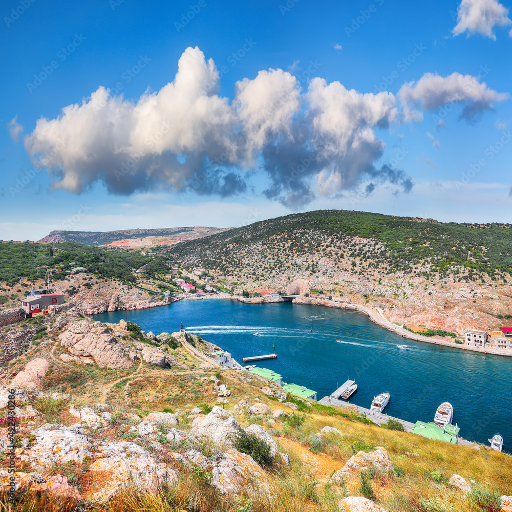 Scenic view of Balaklava bay with yachts and ruines of Genoese fortress Chembalo in Sevastopol city from the height