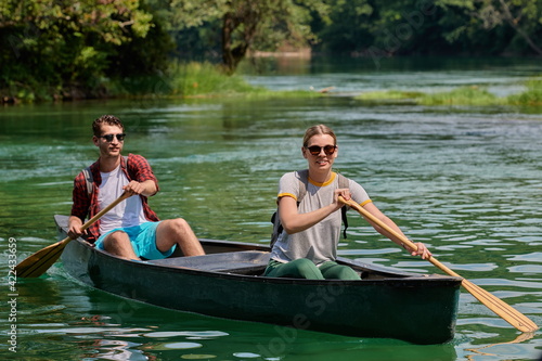 friends are canoeing in a wild river