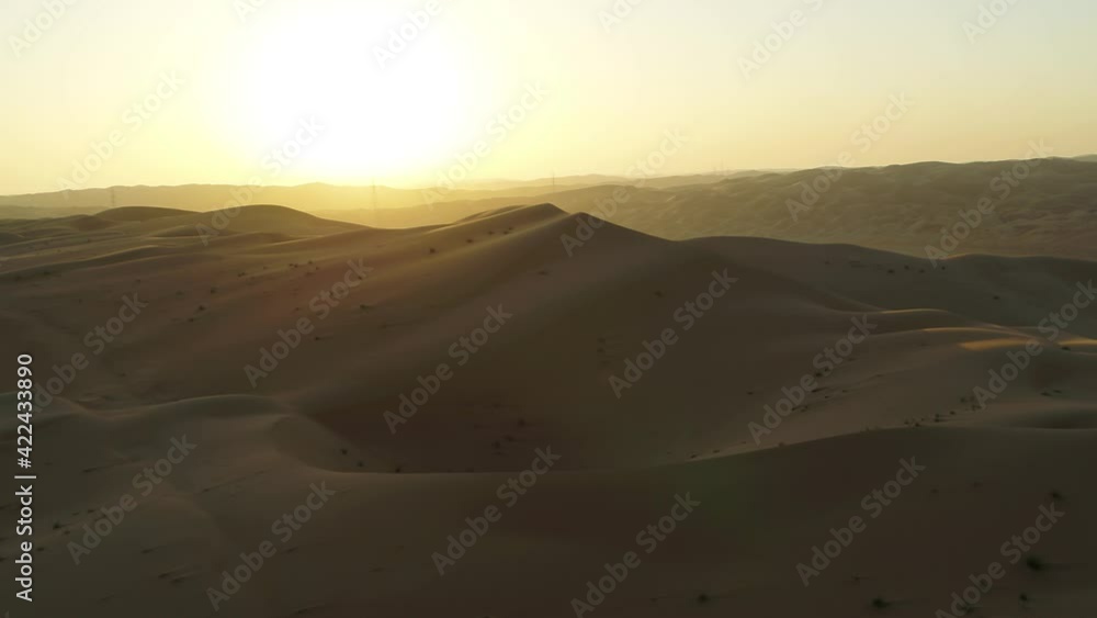 Aerial view of beautiful sandy dunes in Dubai desert at sunset, United Arab Emirates. Aerial view of beautiful sandy dunes in Dubai desert at sunset, United Arab Emirates.