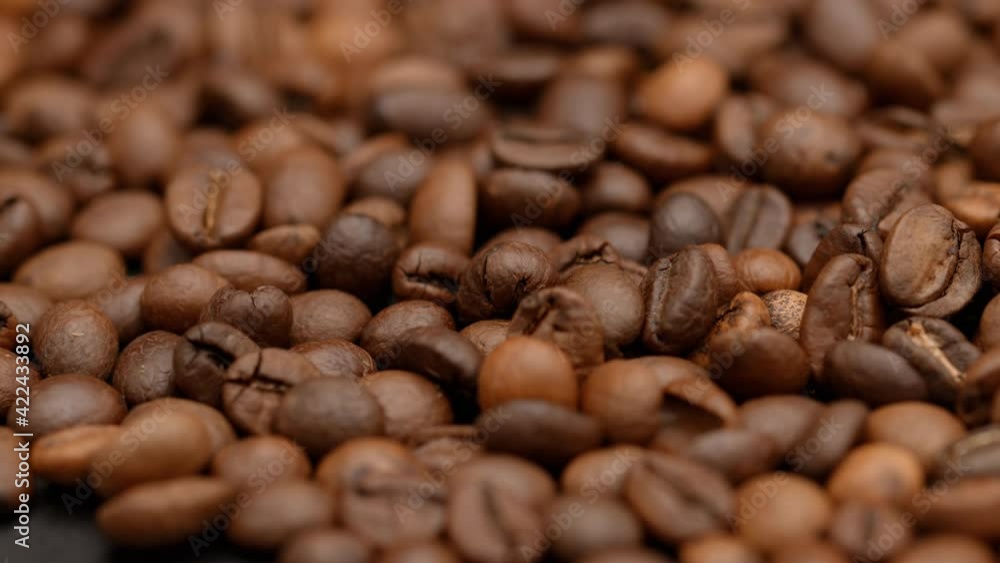 Roasting coffee beans. Close up in fragrant coffee beans smoking. Fragrant coffee beans being roasted. Coffee beans macro rotating Roasting coffee beans. Close up in fragrant coffee beans smoking. Fragrant coffee beans being roasted. Coffee beans macro rotating