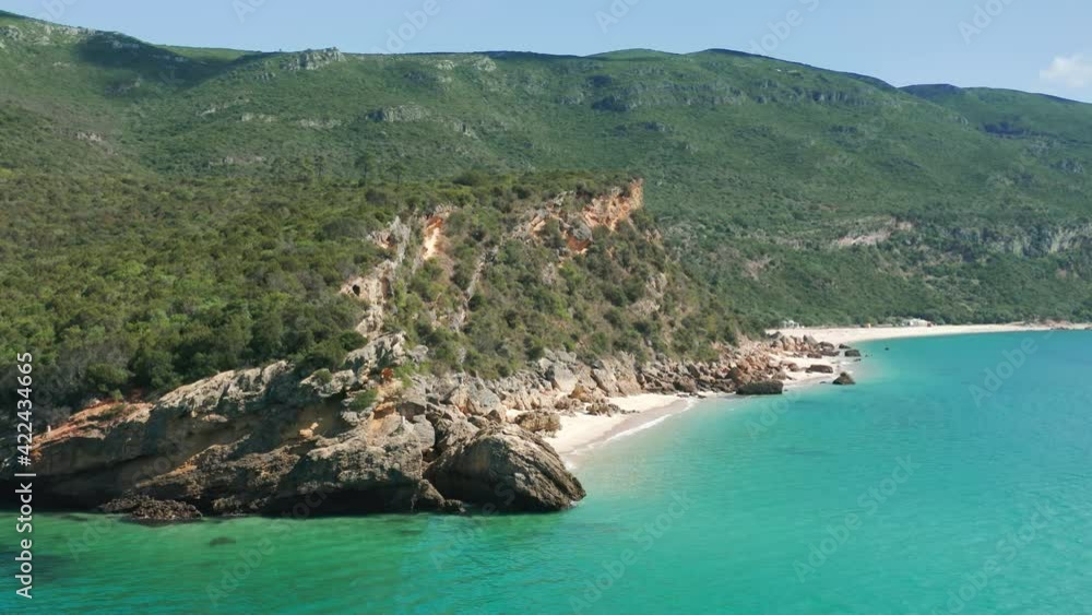Portinho da Arrabida, Portugal. Astonishing seaside destination under the blue sky. Aerial view of the impressive promontory with large cliffs which drop to the Atlantic. High quality 4k footage Portinho da Arrabida, Portugal. Astonishing seaside destination under the blue sky. Aerial view of the impressive promontory with large cliffs which drop to the Atlantic. High quality 4k footage