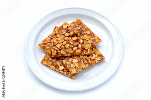 Honey bars with peanuts on white background