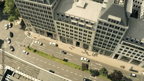 Aerial view of a busy street near a block of houses in Cologne, Germany. Shot in 4K and in two angles.