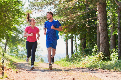 couple enjoying in a healthy lifestyle while jogging on a country road