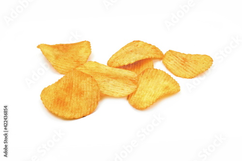Ribbed potatoes snack chips close up isolated on white background.