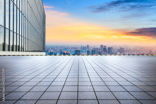 Empty square and city skyline at sunset in Shanghai.