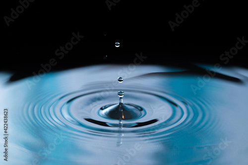 Macro shot of a water drop with blue hues