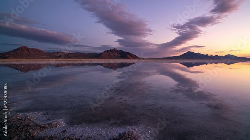 Time lapse of colorful sunrise reflecting over the Great Salt Lake as water covers the Bonneville Salt Flats in Utah. photo