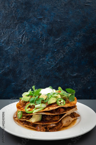 Mexican style pulled chicken tostada stack with all the fixings 