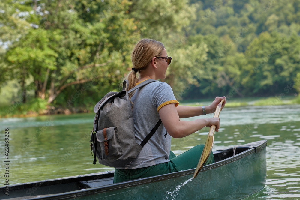 woman adventurous explorer are canoeing in a wild river woman adventurous explorer are canoeing in a wild river