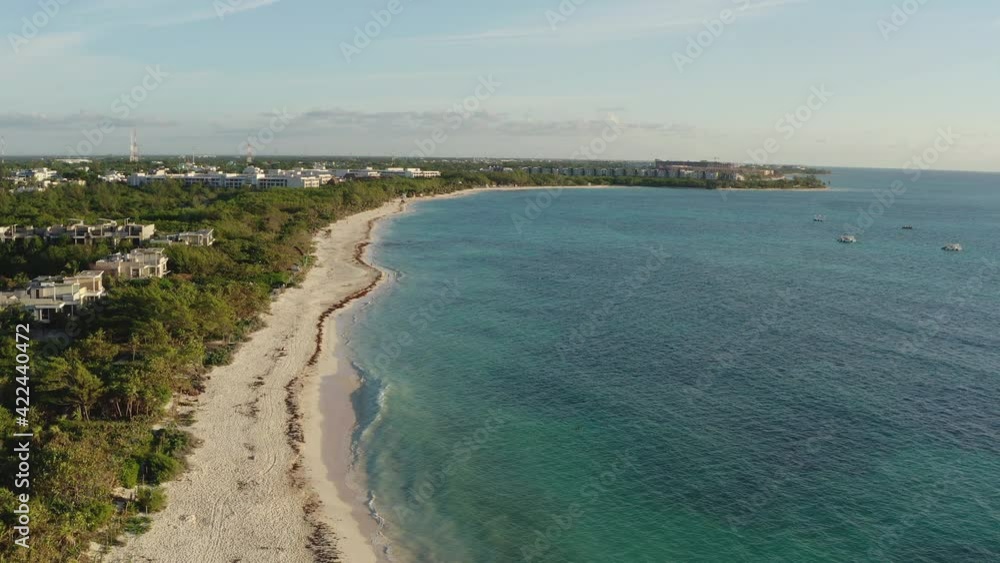 Drone video of a tropical beach on the Caribbean sea. Sandy beach and litter with blue water on the jungle with palm trees.Aerial view of Playa del Carmen Mexico. Drone video of a tropical beach on the Caribbean sea. Sandy beach and litter with blue water on the jungle with palm trees.Aerial view of Playa del Carmen Mexico.