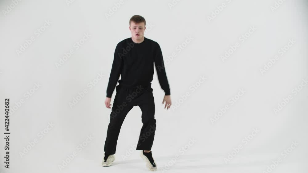 Dancing popping - young man freestyle dancing on cyclorama Dancing popping - young man freestyle dancing on cyclorama