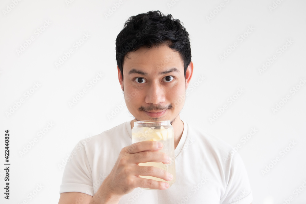 Asian man is drinking iced lemon soda on isolate white background. Asian man is drinking iced lemon soda on isolate white background.